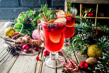 Traditional Christmas Mulled wine, grog or hot spicy sangria cocktail, on old rustic wooden table...