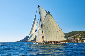 Sailboat under white sails at the regatta. Sailing yacht race