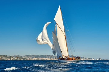 Sailing yacht under full sail at the regatta. Yachting sport  competition © Alvov