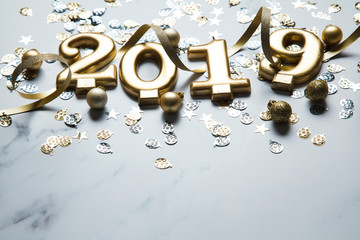 Happy new year 2019 gold background with confetti on a merble background