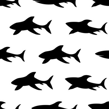 Seamless pattern with silhouettes of sharks.