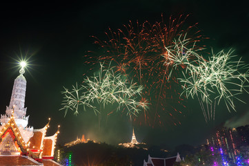 Firework festival ..The most famous firework Pra Nakorn Kiri festival in petchaburi Thailand displaying over three pagodas on the hill in background  temple lighting and bokeh in foreground.