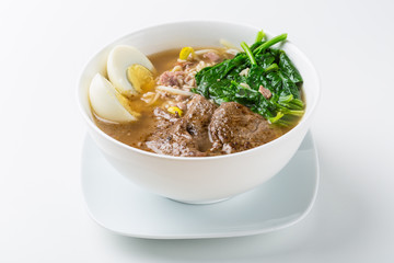 Asian meat broth with steamed greens and egg