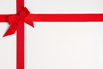 Layout made of red ribbon bow on white background. Mockup, flat lay