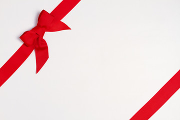 Layout made of red ribbon bow on white background. Mockup, flat lay