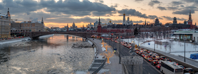 panoramic view of Moscow Kremlin and Moscow river with street illumination at sunset