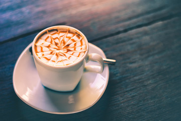 cup cappuccino coffee on wood table and vintage life stlye.