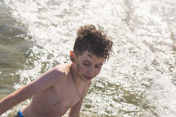 boy in the sea wave. Travel and summer concept