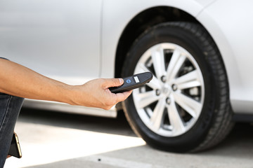 Man checking the pressure in his car tire with digital meter.