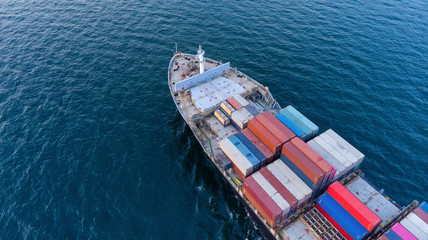 Aerial top view close up of cargo container ship vessel import export container in the ocean.