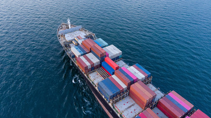 Aerial top view close up of cargo container ship vessel import export container in the ocean.