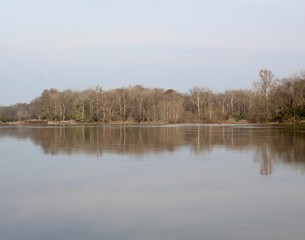 A view of the river on a foggy sunny autumn morning.