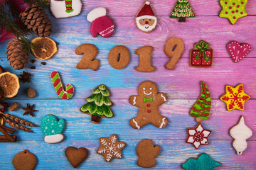 Gingerbread cookies for new 2019 year on wooden background, xmas theme