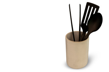 Black kitchen utensils in cup isolated on white background. with clipping path