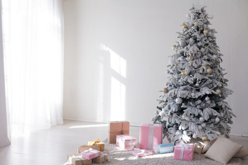Fototapeta na wymiar White Christmas tree decorating new year gifts Interior holiday winter