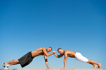 Daily exercise concept. Push ups challenge. Men motivated workout outdoors. Improve endurance by...