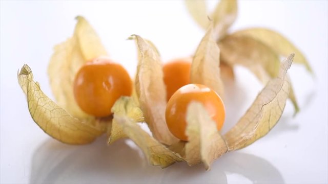 Physalis peruviana. Cape Gooseberries rotated over white background. Ripe fresh Physalis  closeup. Goldenberry. Slow motion 4K UHD video footage. 3840X2160