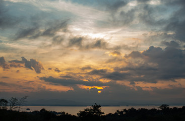 sunrise over Si Nakharin dam at Huay Mae khamin waterfall National Park ,Kanchana buri in Thailand.