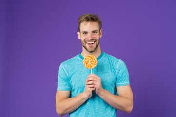 Taste of childhood. Man with bristle likes lollipop. Cheat meal concept. Sugar harmful for health....
