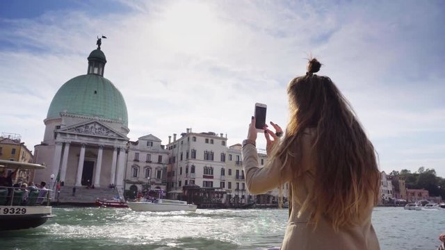 Girl shoots on the phone Grand Canal and San Simeone Piccolo, Venice, Italy