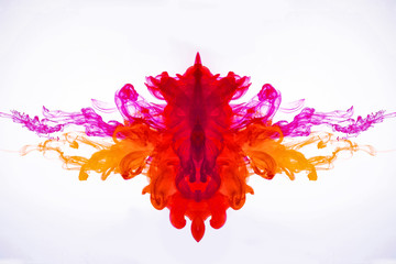 Ink flowing in liquid. Mixing paint under water. Curved smoke was photographed in motion. The drops of acrylic ink flowing in water isolated on white background. Abstract pattern.