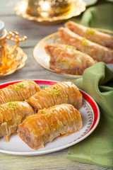 A piece of baklawa on a  plate on a  table, top view, baklava, feast treat ramadan traditional dessert