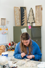Female Artist working on stones mosaic