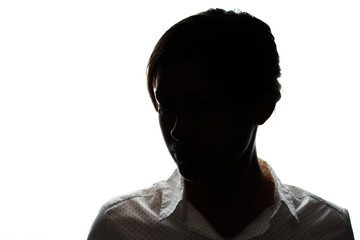 Dark silhouette of a young girl on a white background, the concept of anonymity