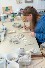 Female Artist working on stones mosaic