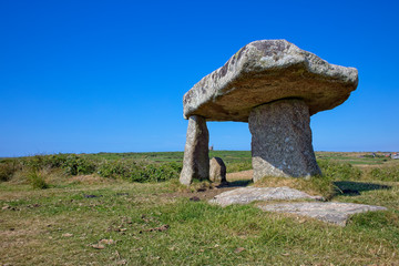 Lanyon Quoit, with a distant mining enginehouse behind, Cornwall, England, UK.