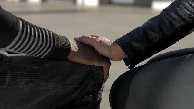 love between men, homosexuality. white man and black man take hands-slow motion