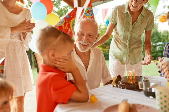 Happy extended family on a garden birthday party