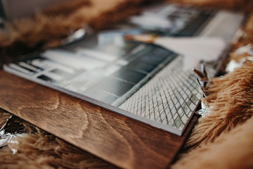 Pages of wedding photobook or wedding album on the sofa with. Open Wedding Photobook