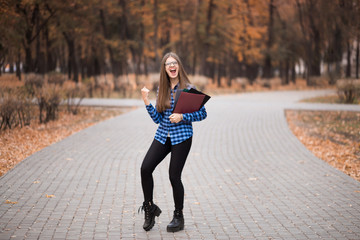 Young happy woman gesturing victory with raised fist, woman passed exams