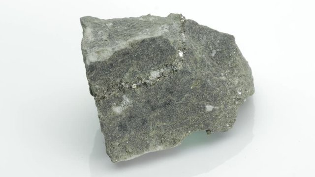 Biotite is a common phyllosilicate mineral within the mica group, from Vesuvius volcano, isolated on a white background, Naples, Italy