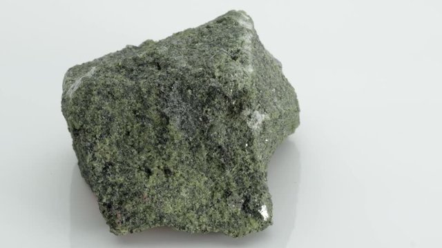Vesuvianite, also known as idocrase, is a green, brown, yellow, or blue silicate mineral from Vesuvius volcano, isolated on a white background, Naples, Italy