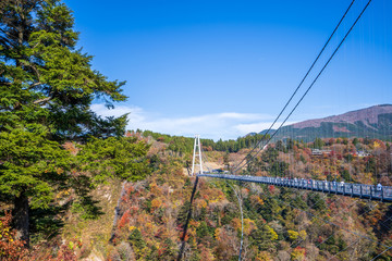 Fototapeta na wymiar Kuju, oita, Japan, November 11, 2018: Kokonoe Yume Suspension Bridge (otsurihashi), the most highest suspension bridge for walkway in Japan.