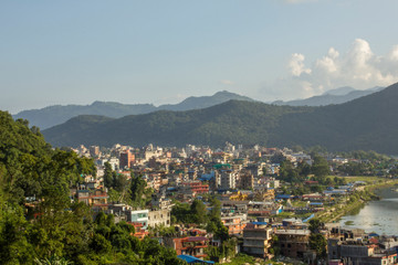 city in a green mountain valley near the lake