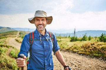 Portrait of smiling man hiking in the mountains