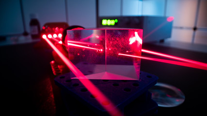 Experiment with red laser in optics lab - obrazy, fototapety, plakaty
