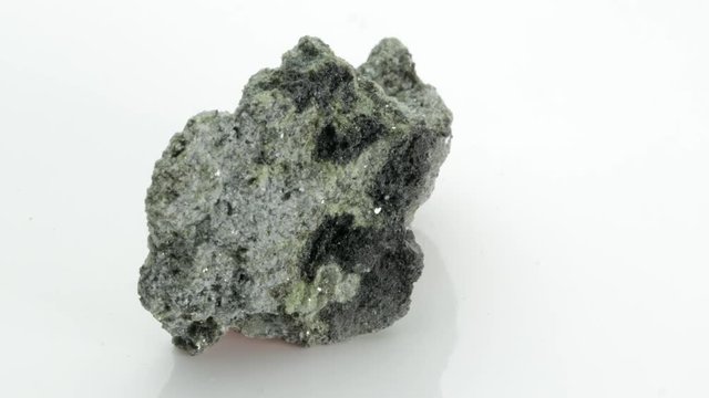 The olivine is a magnesium iron silicate mineral, from Vesuvius volcano, isolated on a white background, Naples, Italy