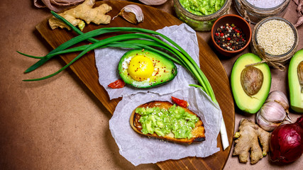 Fototapeta na wymiar Toast with avocado, spices. Raw Organic breakfast Healthy eating. Authentic lifestyle image. copy space, top view
