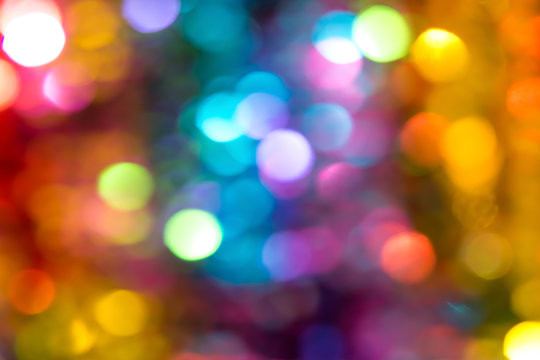 Beautiful multicolored bokeh lights holiday glitter background for Christmas New Year Birthday celebration. High resolution image. Template for backdrop product surface design