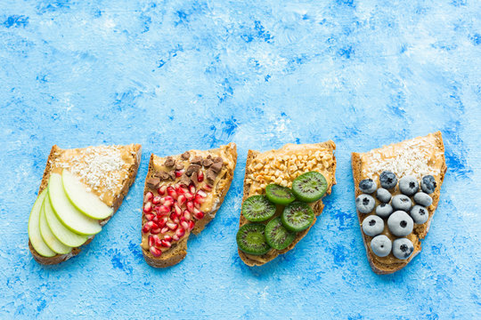 Row of bread slices with various toppings
