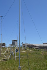 Weather station at the top of the mountain against the blue sky and grass on a Sunny summer day,...