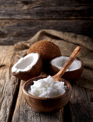 Coconut with Coconut oil  on a wooden background