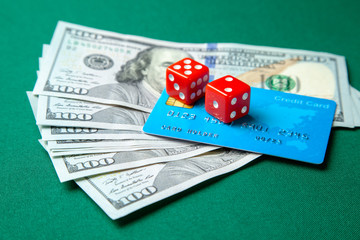 Gambling in casino. Money cash dollars and credit brief with dice for games on the green table