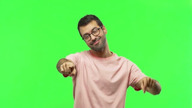 man points finger at you with a confident expression  on green screen chroma key background
