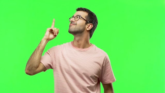 man pointing a great idea and looking up  on green screen chroma key background