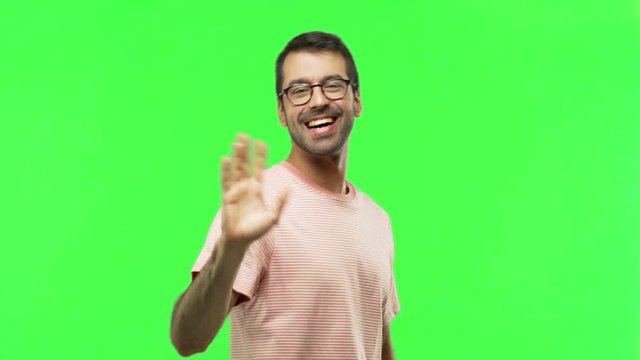 man saluting with hand with happy expression  on green screen chroma key background